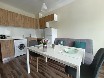 a kitchen with a white dining table and chairs at 20th Residence Studio 1 in Sofia