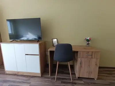 a room with a desk with a tv and a chair at 20th Residence Studio 1 in Sofia
