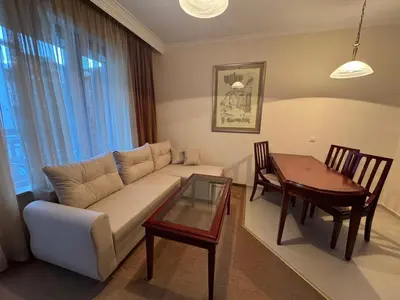 a living room with a couch and a table at Downtown Bansko Resort in Bansko
