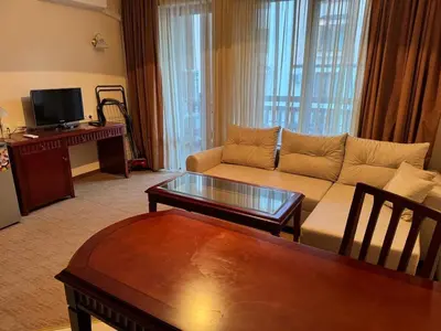 a living room with a couch and a table at Downtown Bansko Resort in Bansko