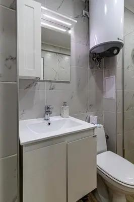 a white bathroom with a sink and a toilet at Student City Studio With Mountain View Balcony and Underground Parking 1 in Sofia