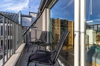 a balcony with two chairs and a window at Student City Studio With Mountain View Balcony and Underground Parking 1 in Sofia