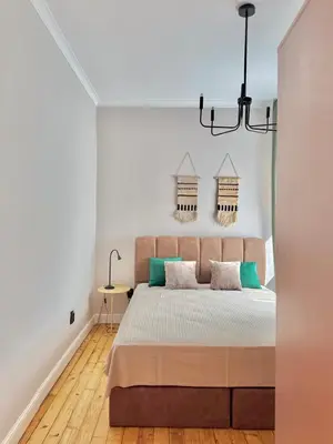 a bedroom with a large bed and a chandelier at Central Luxury Stay Sofia Center by Top Kvartiri Ltd in Sofia