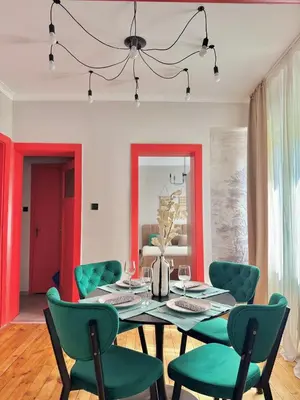 a dining room with a table and green chairs at Central Luxury Stay Sofia Center by Top Kvartiri Ltd in Sofia