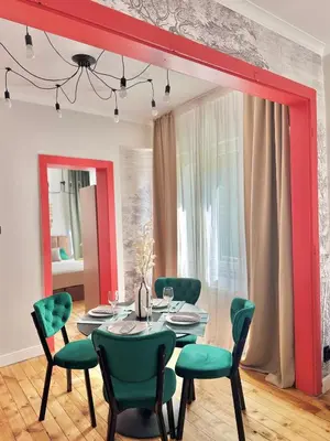 a dining room with a table and green chairs at Central Luxury Stay Sofia Center by Top Kvartiri Ltd in Sofia