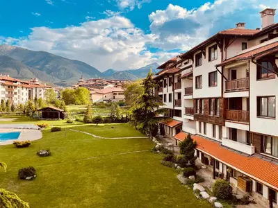 a view of a city with a lawn and buildings at Mountain View Apartment at Bansko Royal Towers in Bansko