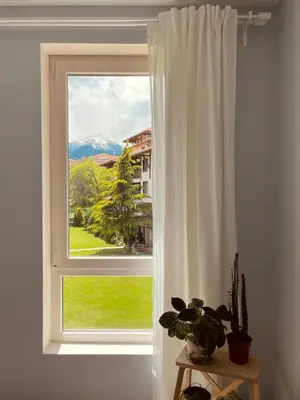 a window with a view of a mountain at Mountain View Apartment at Bansko Royal Towers in Bansko