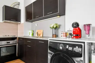 a kitchen with a washer and dryer on a counter at BudgetWork-Friendly Apartment near Business Park in Sofia