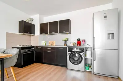 a kitchen with a refrigerator and a washing machine at BudgetWork-Friendly Apartment near Business Park in Sofia