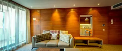 a living room with a couch and a table at Ruskovets Thermal SPA & Ski Resort in Bansko