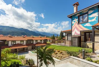 a house with a mural on the side of it at Ruskovets Thermal SPA & Ski Resort in Bansko