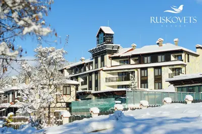 a building covered in snow in front at Ruskovets Thermal SPA & Ski Resort in Bansko