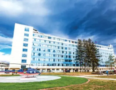 a large white building with a plane in front of it at Luxe Apartment Pana Green Residence Panagyurishte in Panagyurishte