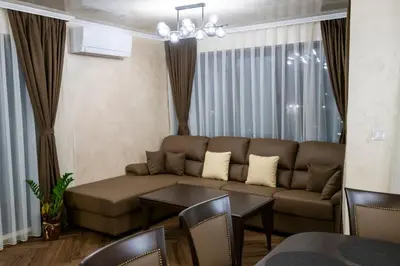 a living room with a couch and a table at Luxe Apartment Pana Green Residence Panagyurishte in Panagyurishte
