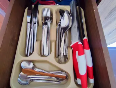 a tray with utensils in a drawer at Deluxe Apartment 