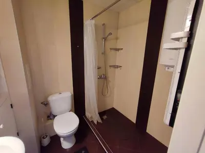 a bathroom with a toilet and a shower at Deluxe Apartment 