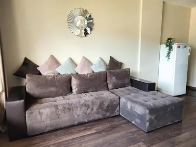 a couch in a living room with a mirror at Deluxe Apartment 