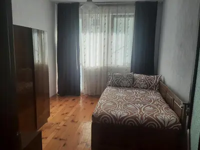 a living room with a couch and a window at Апартамент Ризови in Sandanski