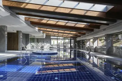a swimming pool with blue tiles in a building at Grand studio in 4star SPA resort in Bansko in Bansko