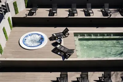 an overhead view of a deck with chairs and a pool at Grand studio in 4star SPA resort in Bansko in Bansko