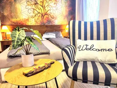 a living room with a bed and a table and a chair at Large 1bd apartment in 4star SPA resort Bansko in Bansko