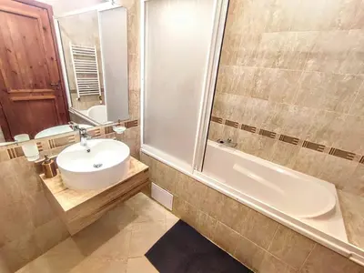 a bathroom with a sink and a toilet and a tub at Large 1bd apartment in 4star SPA resort Bansko in Bansko