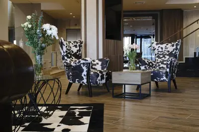 a living room with chairs and a table with flowers at Large 1bd apartment in 4star SPA resort Bansko in Bansko