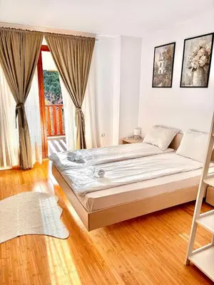 a bedroom with a large bed and a large window at Wood Fireplace Duplex near Pamporovo - Parking, Sleeps 6 in Smolyan