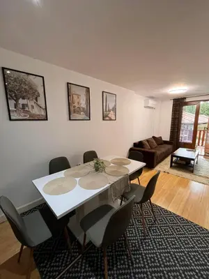 a living room with a white table and chairs at Wood Fireplace Duplex near Pamporovo - Parking, Sleeps 6 in Smolyan