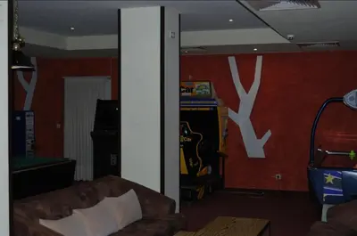 a living room with a couch and a video game at Лари Б01 in Borovets