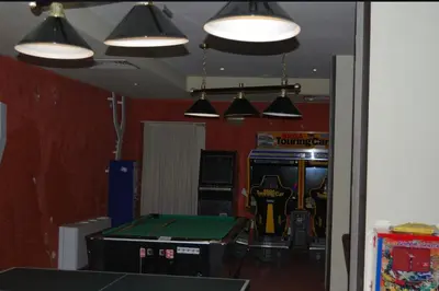a room with a ping pong table and pendant lights at Лари Б01 in Borovets