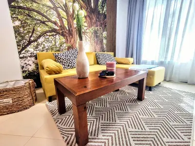 a living room with a couch and a coffee table at Comfy 1bd apartment in 4star SPA resort Bansko in Bansko