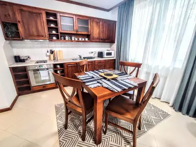 a kitchen with a wooden dining room table and chairs at Comfy 1bd apartment in 4star SPA resort Bansko in Bansko
