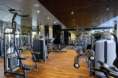 a gym with several treadmills and machines at Comfy 1bd apartment in 4star SPA resort Bansko in Bansko