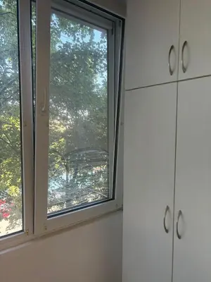 a window in a white room with a view at ApartSofiaMusagenica in Sofia