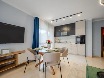a kitchen and dining room with a table and chairs at The Boulevard Luxury Apartment 3 in Sofia