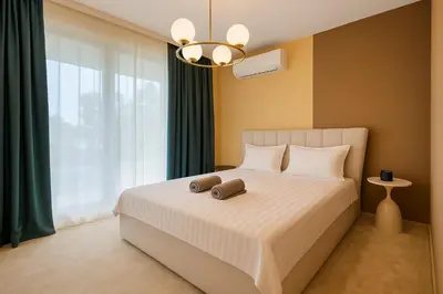 a bedroom with a white bed with a large window at The Boulevard Luxury Apartment 3 in Sofia