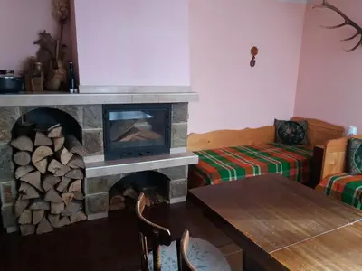 a living room with a fireplace with a tv at Guest House AHP in Mala Tsŭrkva