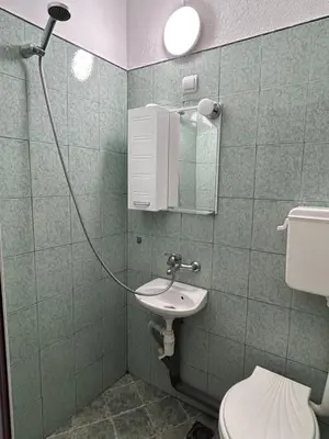 a bathroom with a toilet and a sink and a mirror at Семеен хотел Модерния хан in Zărkwischte