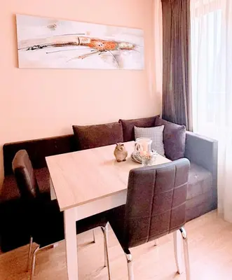 a dining room table with chairs and a couch at Cozy One Bedroom Apartment in Bansko Near Gondola with Wi Fi in Bansko