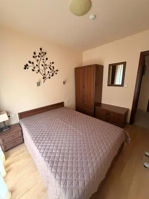 a bedroom with a bed and a dresser and aintendent at Cozy One Bedroom Apartment in Bansko Near Gondola with Wi Fi in Bansko
