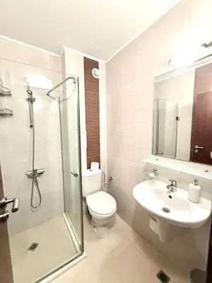 a bathroom with a shower and a toilet and a sink at Cozy One Bedroom Apartment in Bansko Near Gondola with Wi Fi in Bansko