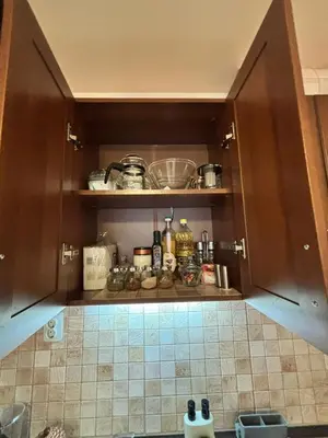 a kitchen with brown cabinets and a tiled floor at Cozy One Bedroom Apartment in Bansko Near Gondola with Wi Fi in Bansko