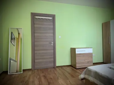 a bedroom with a door and a dresser with a mirror at City Modern & Cozy Apartment for 4 Guests in Sofia, Lozenets in Sofia