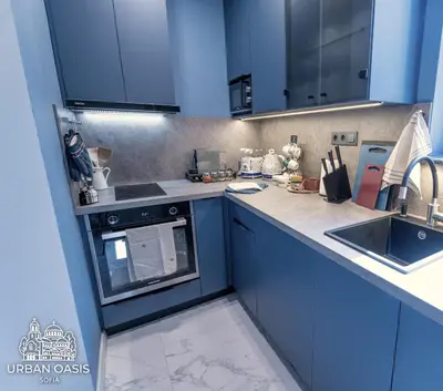 a kitchen with blue cabinets and a sink at Urban Oasis Sofia in Sofia
