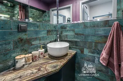 a bathroom with a bowl sink on a counter at Urban Oasis Sofia in Sofia