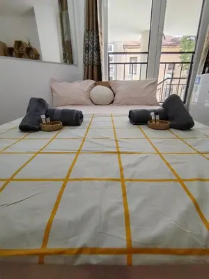 a large bed with pillows on top of it at Good Mood Room in Plovdiv