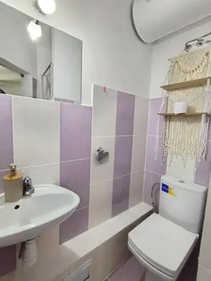 a bathroom with a toilet and a sink at Good Mood Room in Plovdiv
