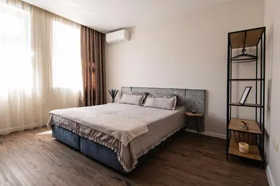 a bedroom with a bed and a book shelf at Kapana by V2 in Plovdiv