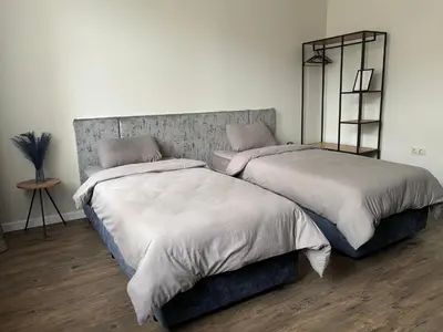 two beds sitting next to each other in a bedroom at Kapana by V2 in Plovdiv